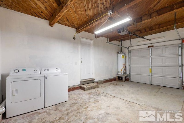 garage with water heater, a garage door opener, and independent washer and dryer