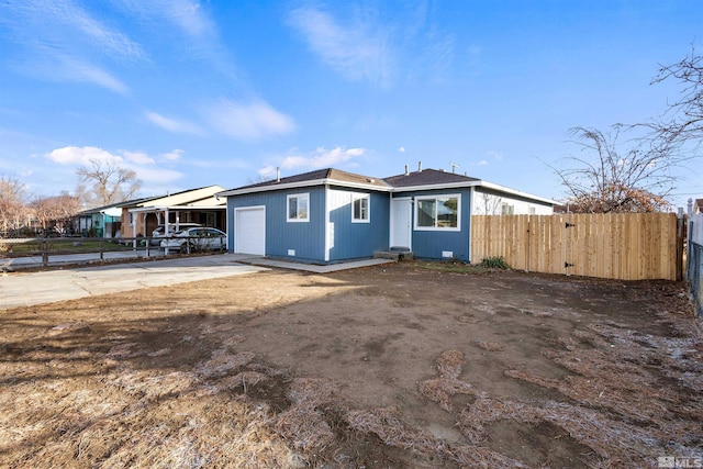 rear view of property featuring a carport and a garage