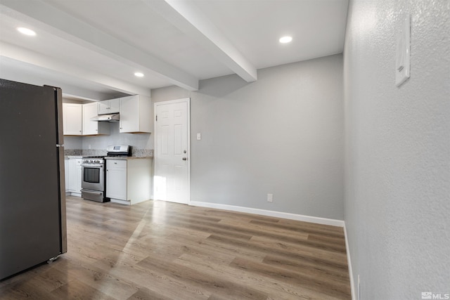 kitchen with stainless steel appliances, white cabinetry, light hardwood / wood-style floors, and beamed ceiling