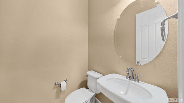 bathroom featuring sink and toilet