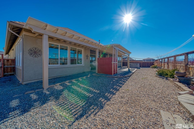 back of house featuring a pergola