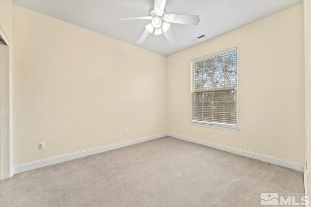 unfurnished room with light colored carpet and ceiling fan