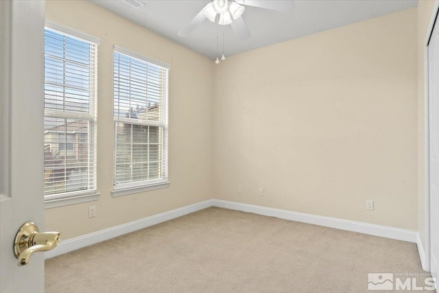 empty room featuring ceiling fan and light carpet