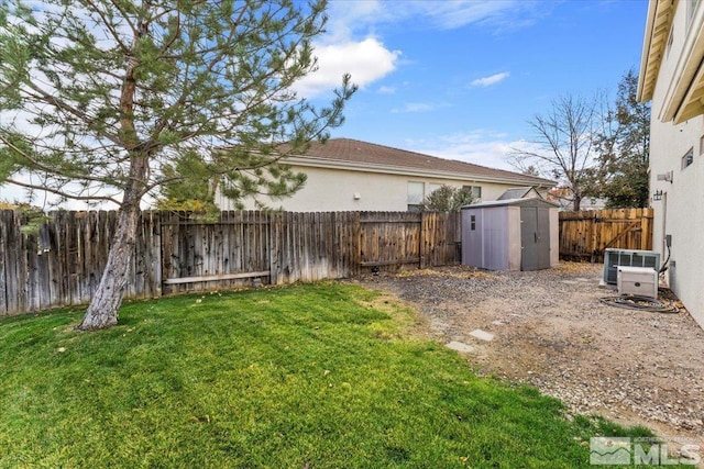 view of yard with central AC and a shed