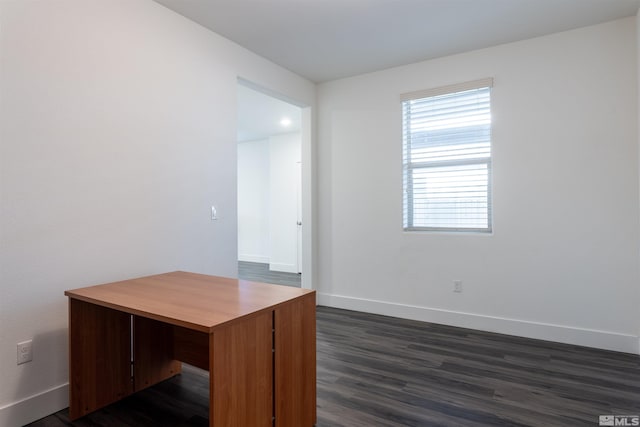 unfurnished office with dark wood-type flooring