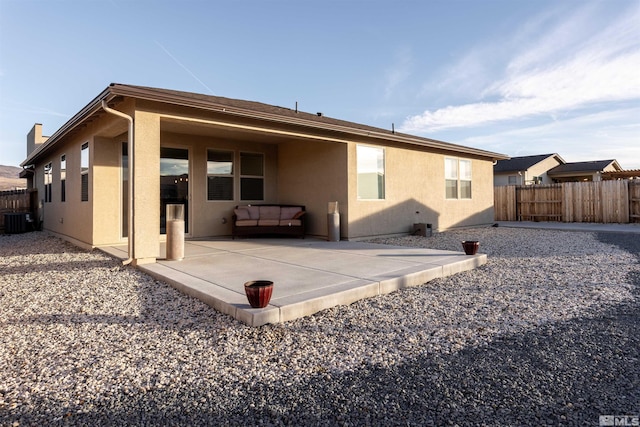 rear view of house featuring a patio area and central air condition unit