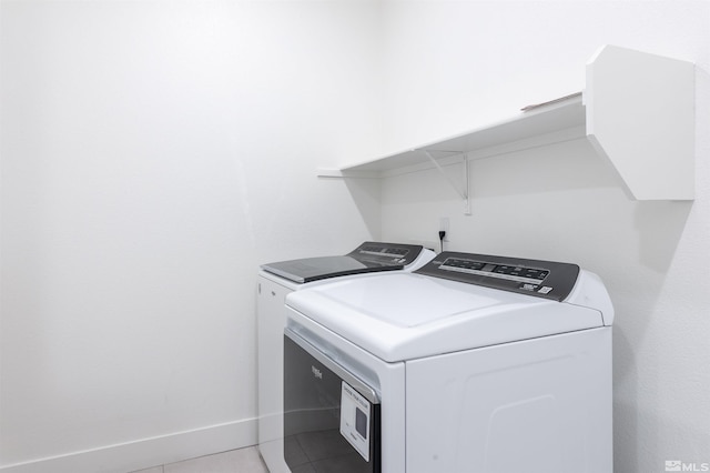 laundry room with tile patterned flooring and washer and clothes dryer