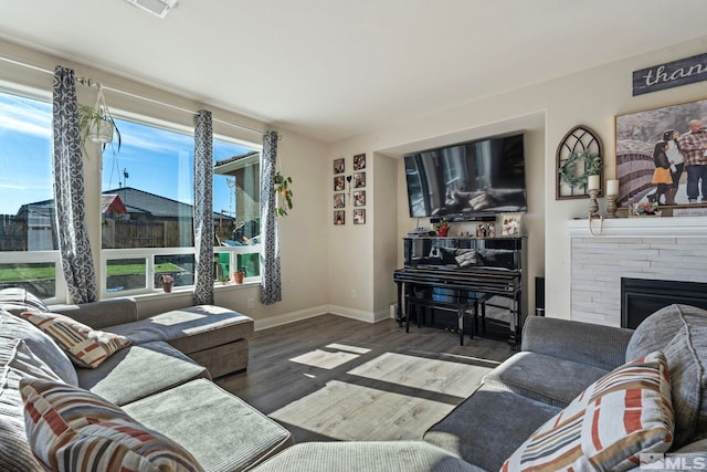 living room with plenty of natural light and dark hardwood / wood-style floors