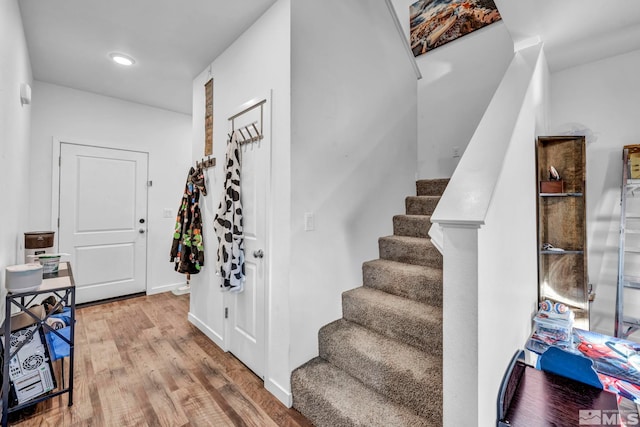 stairway featuring hardwood / wood-style flooring