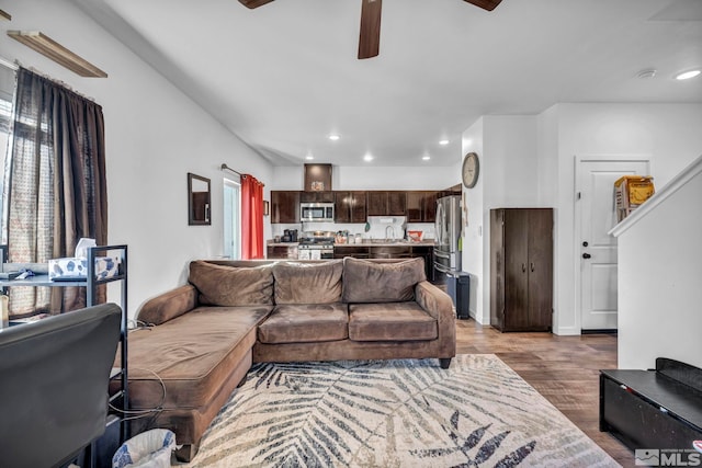 living room featuring ceiling fan, a wealth of natural light, and wood-type flooring