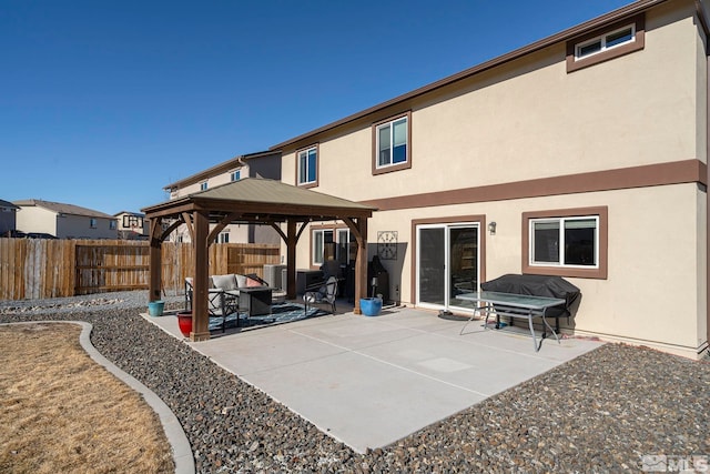 rear view of property featuring a gazebo, a patio, and cooling unit