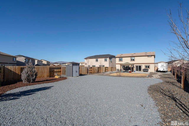 back of house featuring a patio and a shed