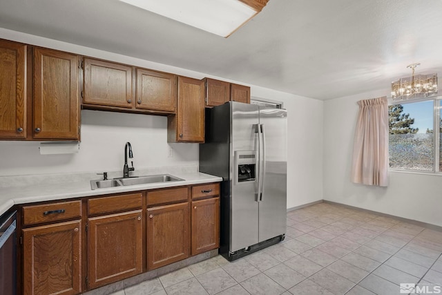 kitchen featuring an inviting chandelier, appliances with stainless steel finishes, and sink