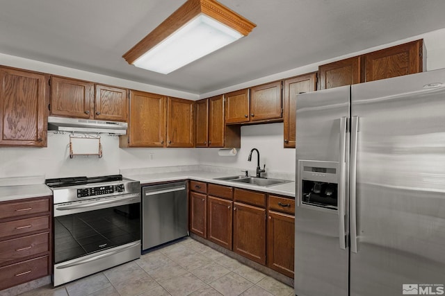 kitchen featuring sink, light tile patterned floors, and stainless steel appliances