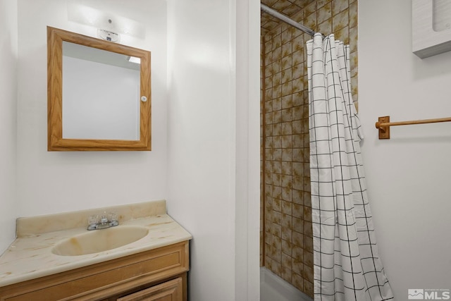 bathroom with walk in shower and vanity