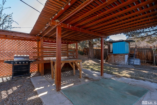 view of patio / terrace featuring area for grilling and a storage shed