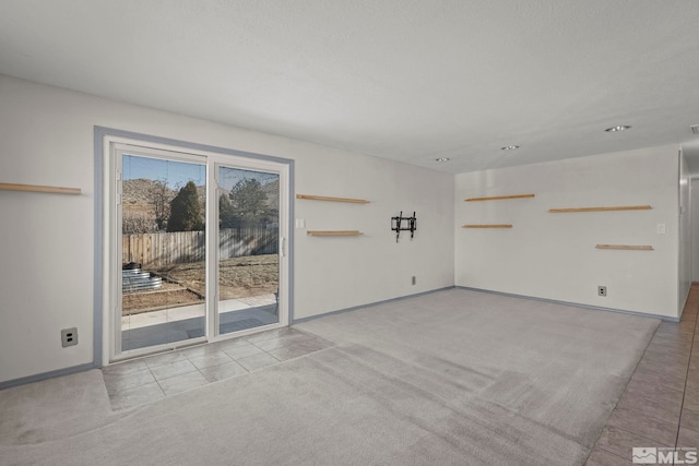 unfurnished living room featuring light tile patterned floors and a wealth of natural light