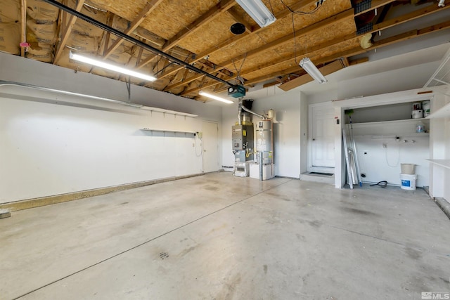 garage featuring a garage door opener and strapped water heater