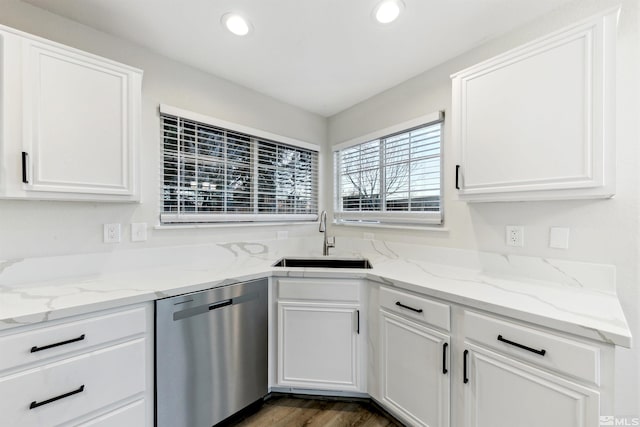 kitchen with white cabinetry, sink, light stone counters, and dishwasher