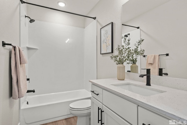 full bathroom featuring vanity, toilet, shower / washtub combination, and wood-type flooring