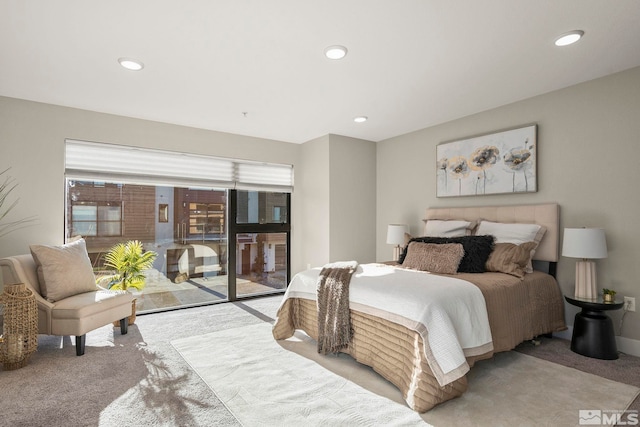 bedroom featuring light carpet and access to exterior