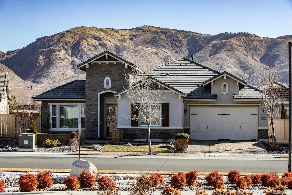 view of front facade with a mountain view and a garage