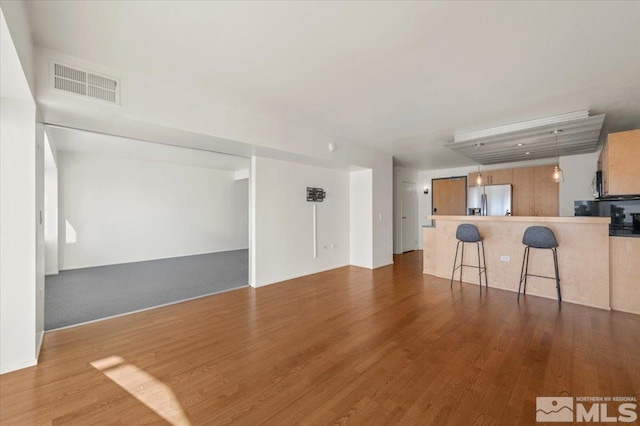 unfurnished living room featuring wood-type flooring