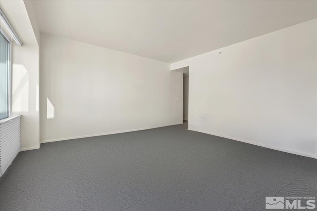 carpeted empty room with a healthy amount of sunlight