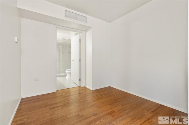 empty room with wood-type flooring