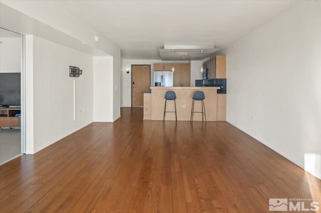 unfurnished living room with dark wood-type flooring