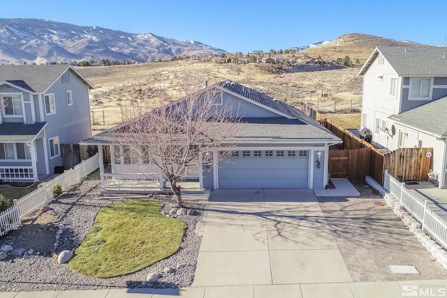 view of front of property with a garage and a mountain view