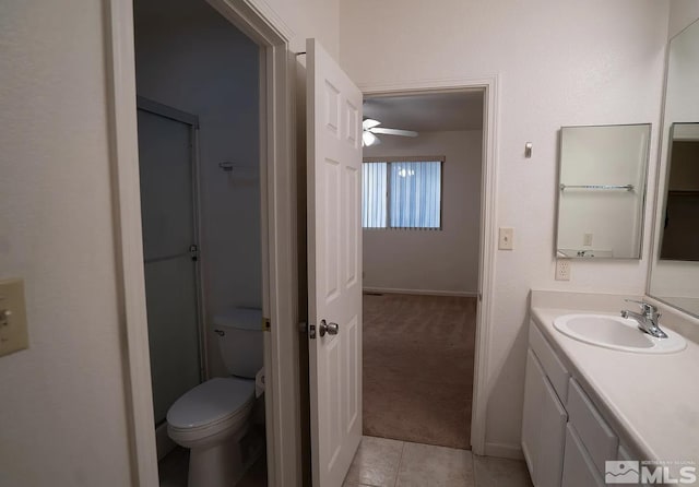 bathroom featuring vanity, tile patterned floors, and toilet