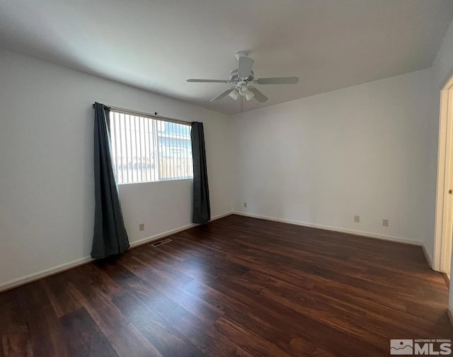 unfurnished room featuring dark wood-type flooring and ceiling fan