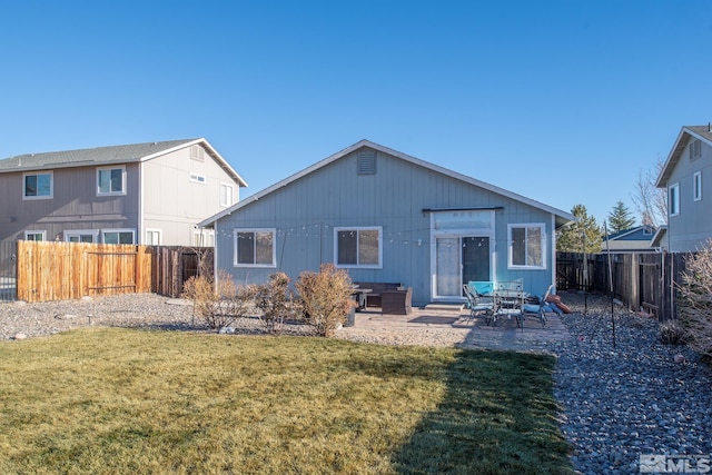 back of house featuring a patio and a yard