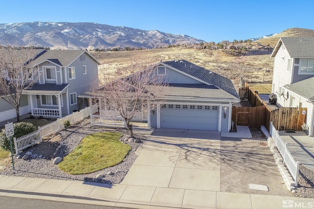 view of property with a garage and a mountain view