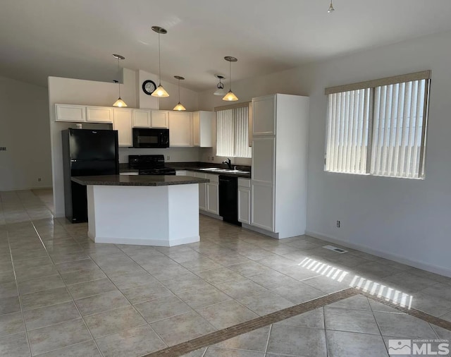 kitchen featuring sink, white cabinets, hanging light fixtures, a center island, and black appliances