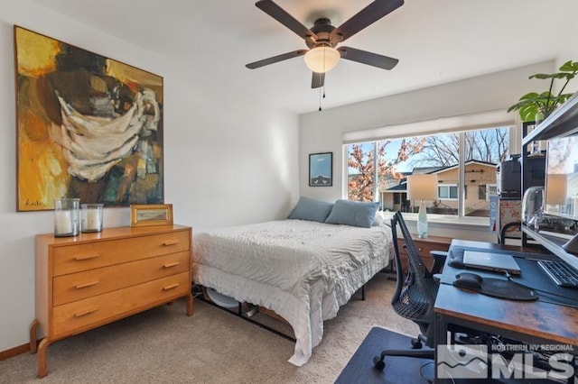 bedroom featuring ceiling fan and carpet