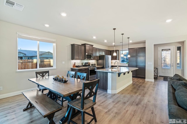 dining room with sink and light hardwood / wood-style floors