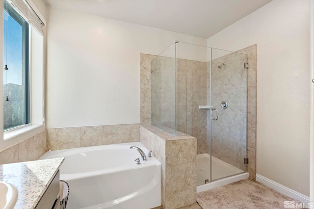 bathroom featuring vanity, a wealth of natural light, and plus walk in shower