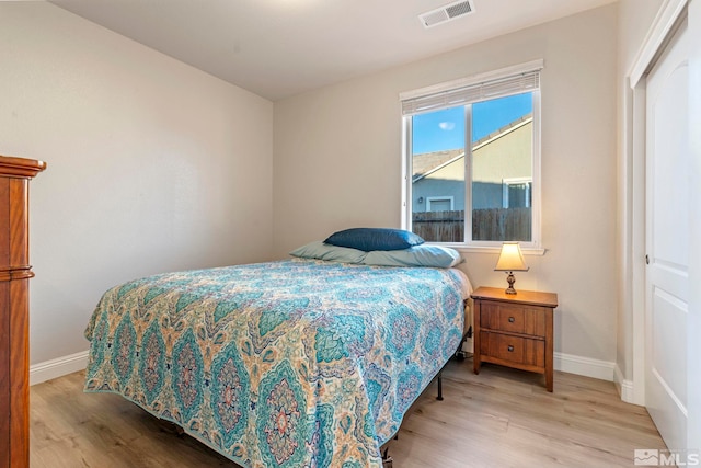 bedroom with a closet and light hardwood / wood-style flooring