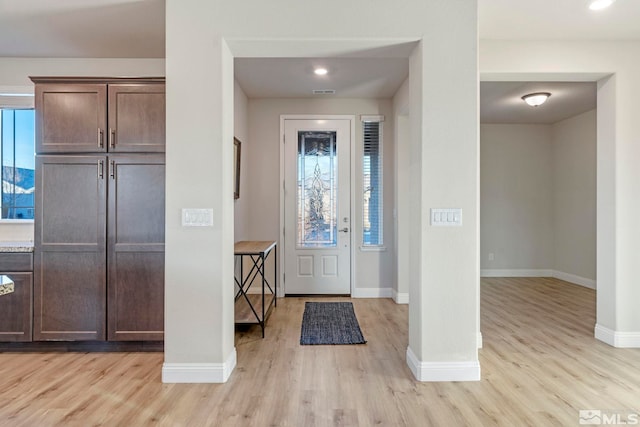 entrance foyer featuring plenty of natural light and light hardwood / wood-style floors