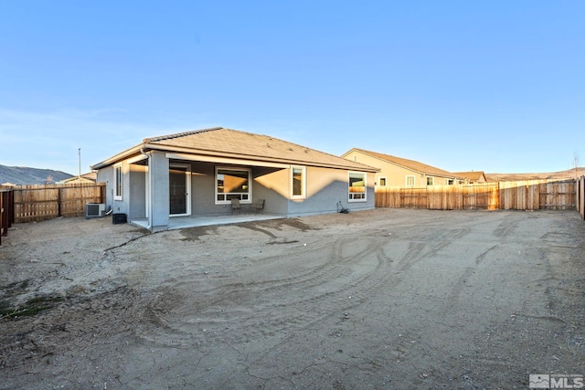 back of house with a patio area and central air condition unit