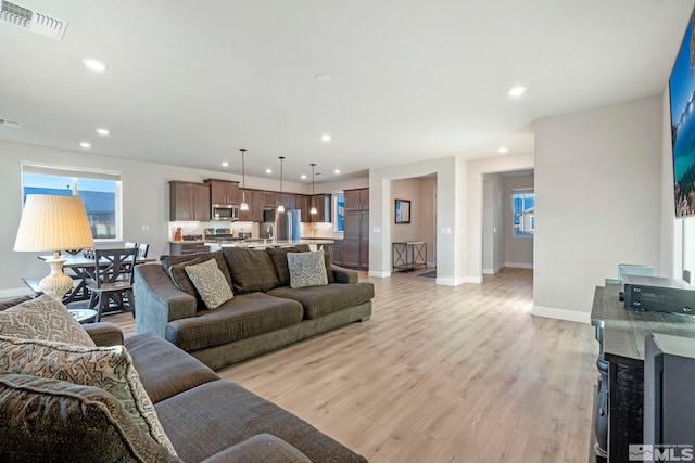 living room with light hardwood / wood-style floors