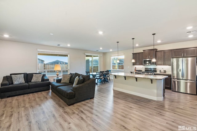 living room featuring sink and light wood-type flooring