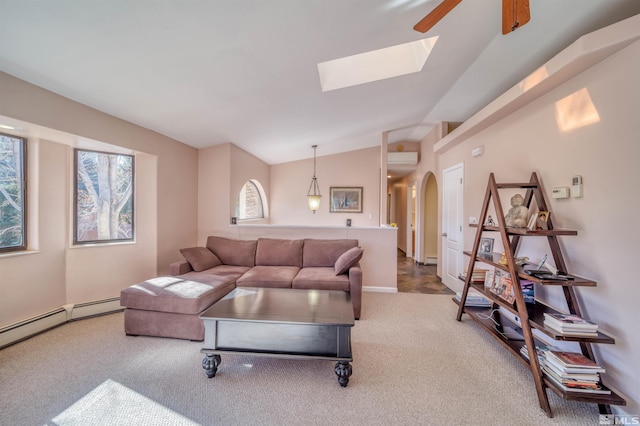 living room featuring lofted ceiling, ceiling fan, a wall mounted AC, carpet floors, and a baseboard radiator