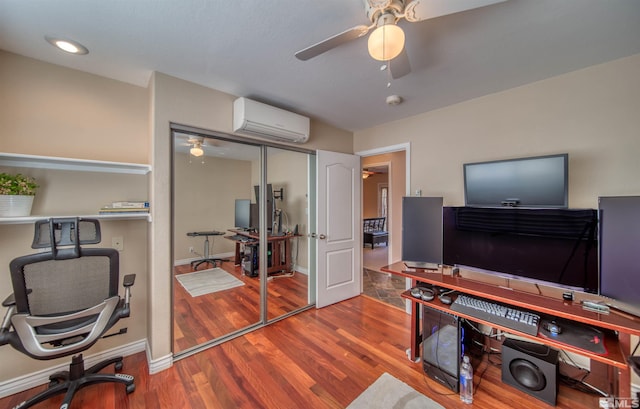 office with wood-type flooring, a wall mounted air conditioner, and ceiling fan