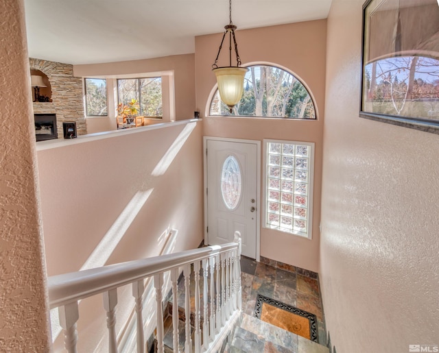 foyer with a fireplace and a healthy amount of sunlight