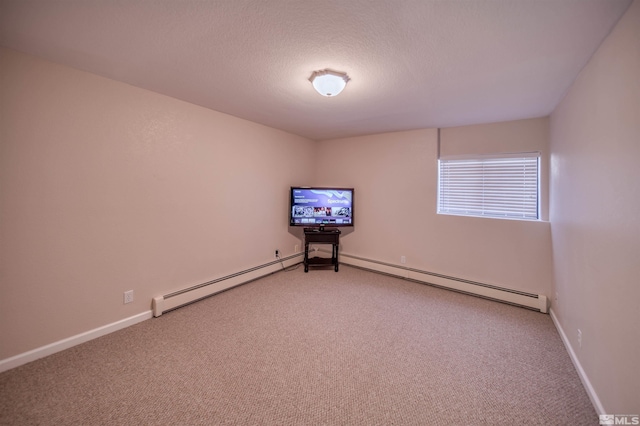 spare room featuring carpet flooring, a textured ceiling, and baseboard heating