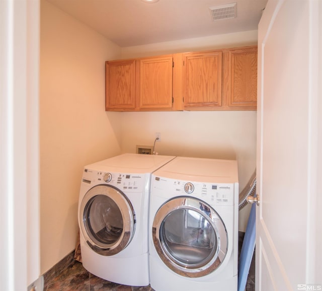 laundry area featuring independent washer and dryer and cabinets