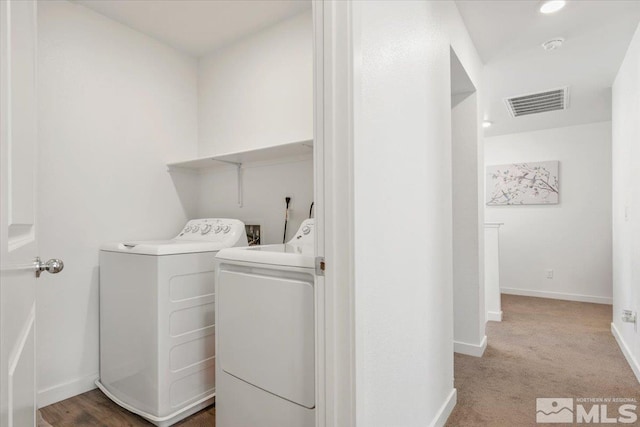 laundry room with washing machine and dryer and carpet